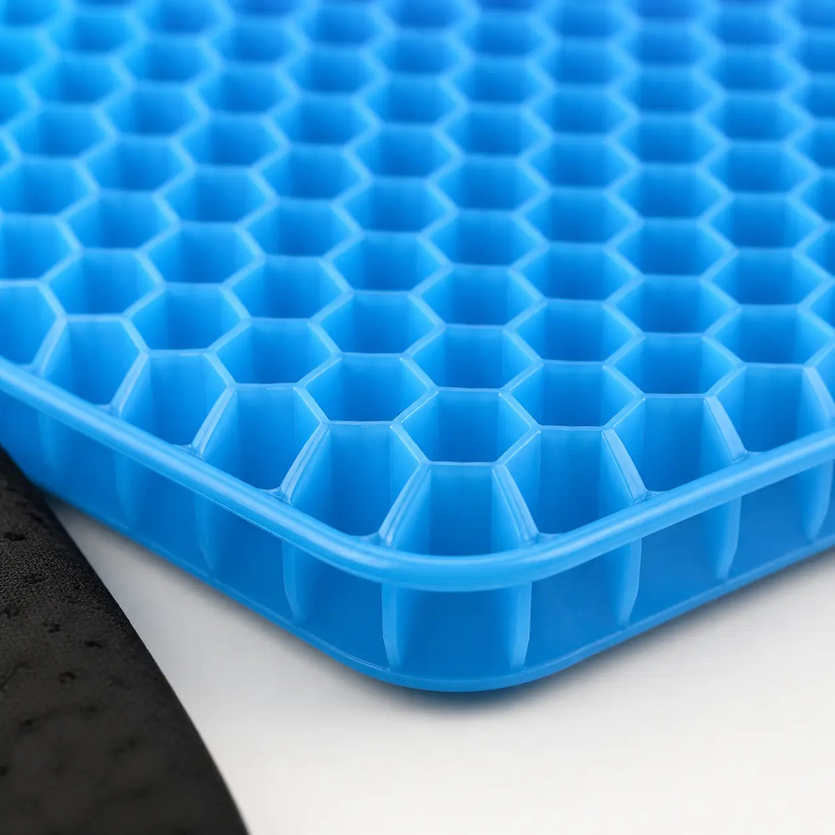 Close-up of the flexible honeycomb structure of the GlowTales gel seat cushion.