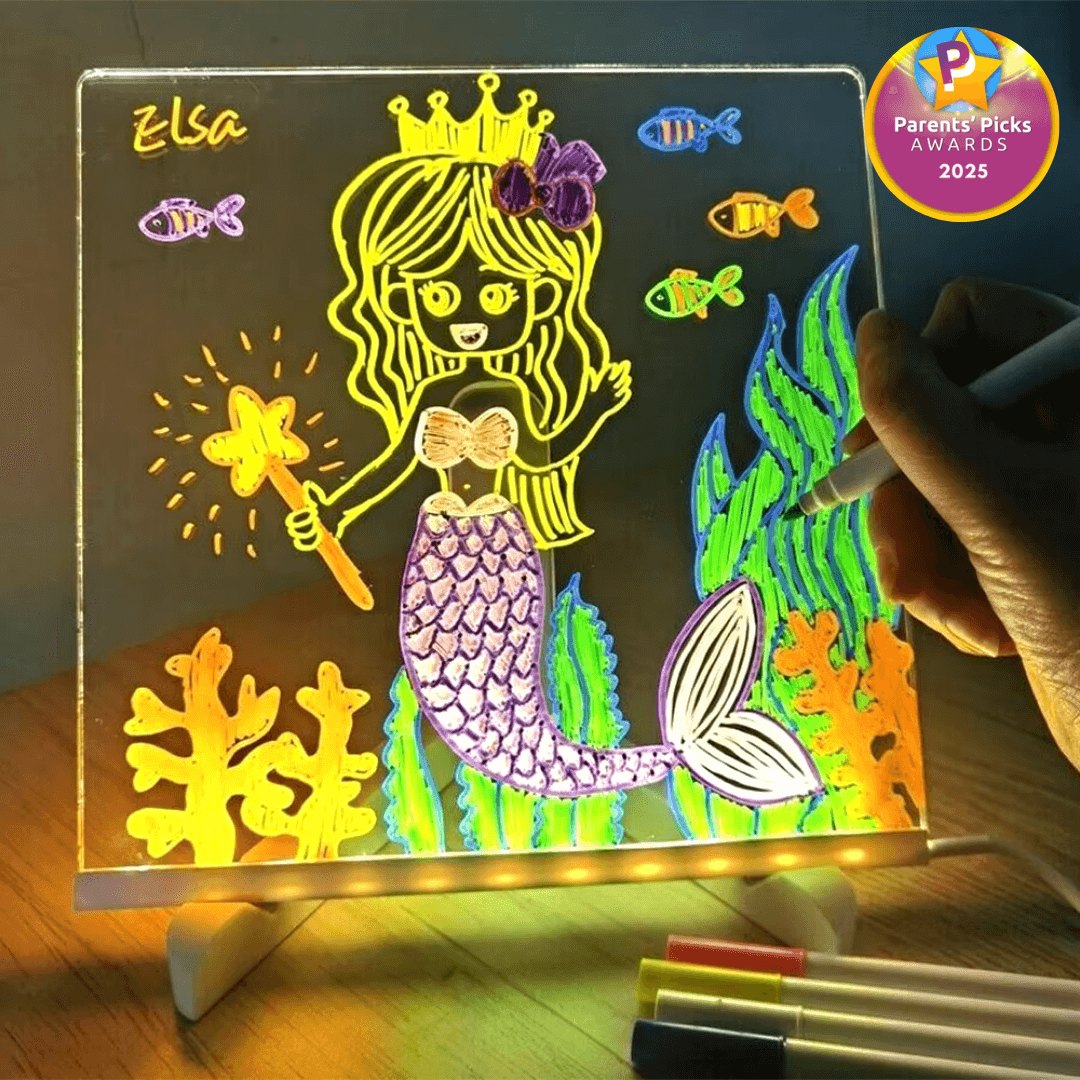 Child drawing a glowing neon mermaid on the LED drawing board
