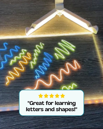 Bright neon strokes drawn with liquid chalk markers on an LED board