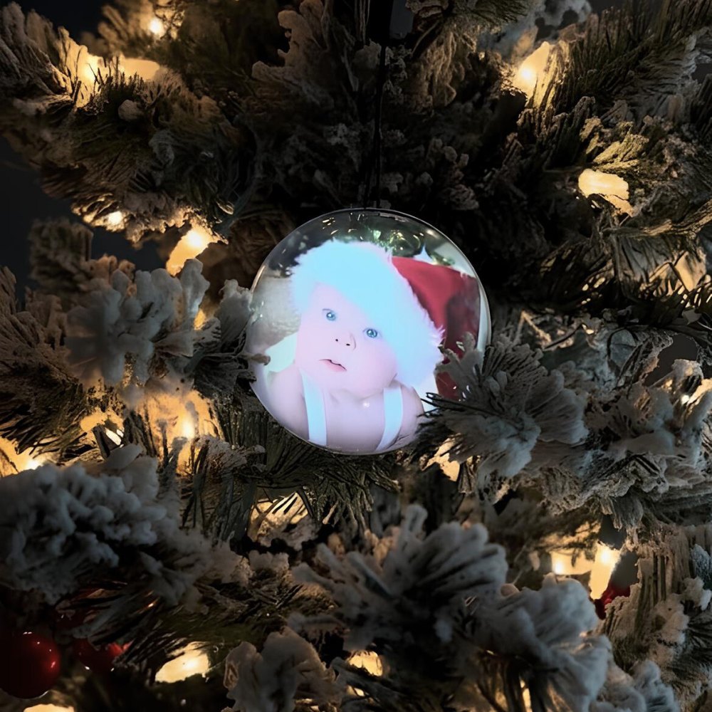 Video globe hanging on a Christmas tree playing a baby video